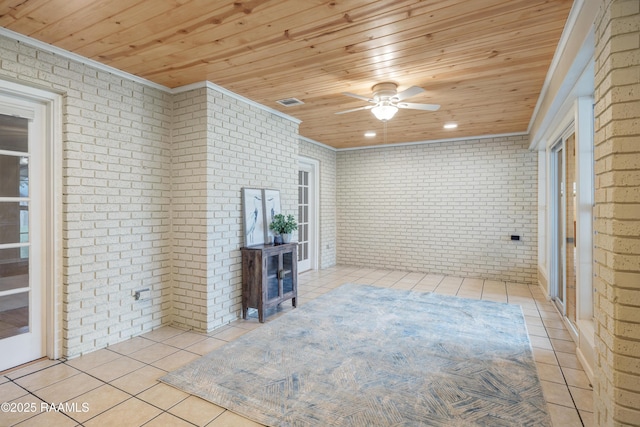 unfurnished sunroom featuring wood ceiling, ceiling fan, and a wood stove