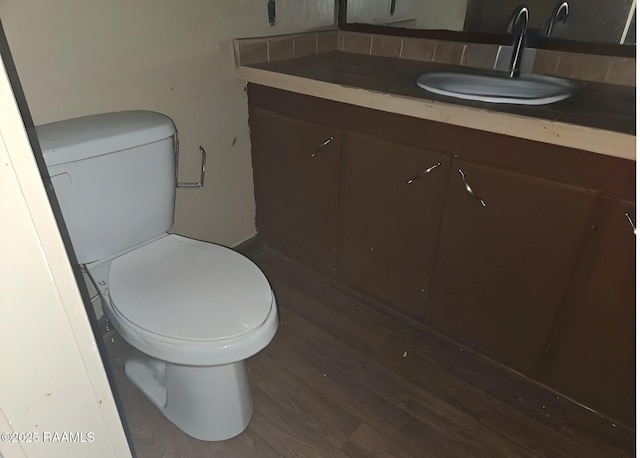 bathroom with vanity, hardwood / wood-style floors, and toilet