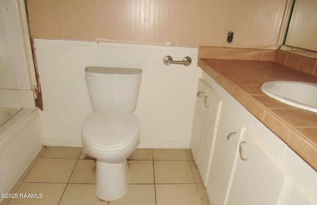 bathroom with vanity, tile patterned floors, and toilet