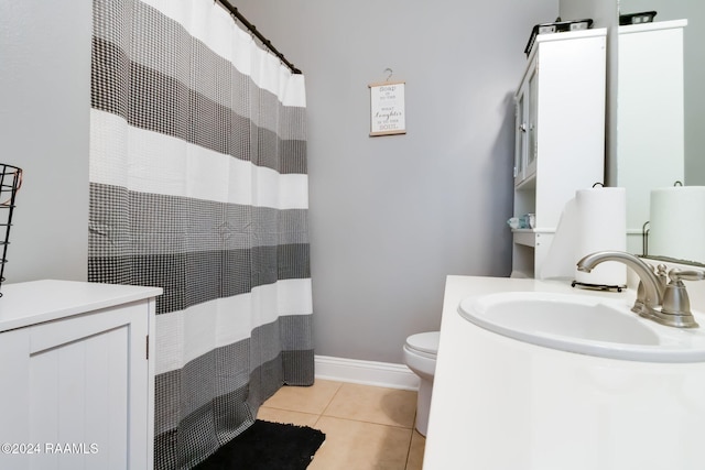 bathroom with vanity, toilet, and tile patterned flooring