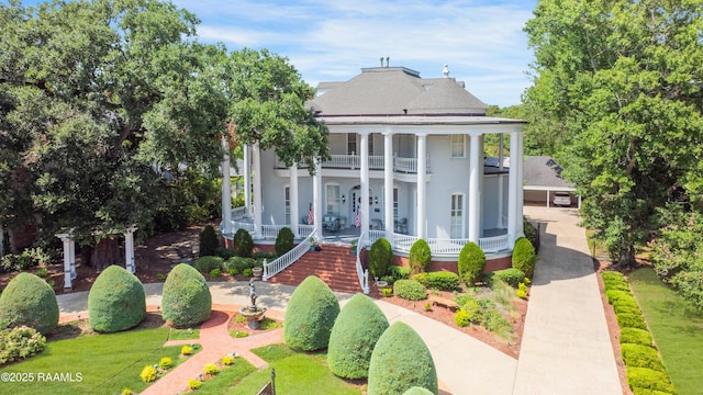 neoclassical / greek revival house with a balcony and covered porch