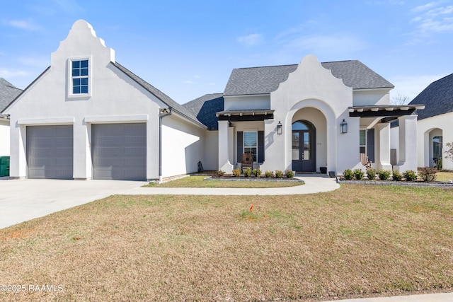 view of front of house featuring a garage, a front yard, and french doors