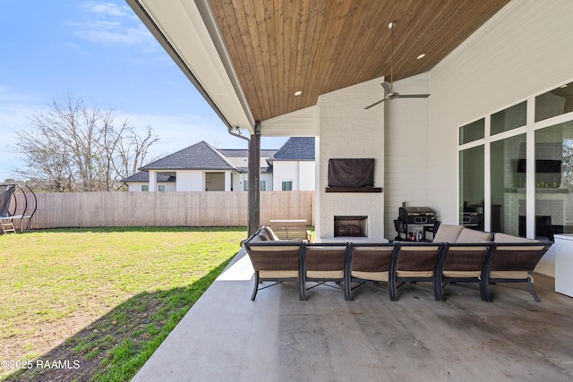 view of patio with ceiling fan, grilling area, and an outdoor living space with a fireplace