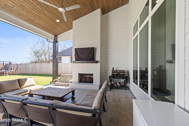 view of patio / terrace featuring an outdoor living space with a fireplace, ceiling fan, and a grill