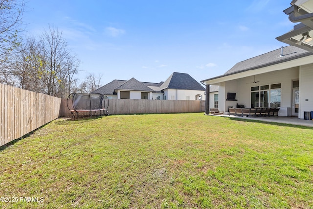 view of yard with a trampoline, a patio area, and ceiling fan