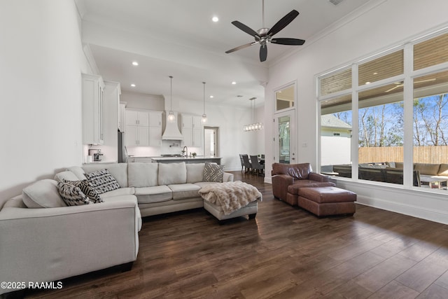 living room with ceiling fan, ornamental molding, dark hardwood / wood-style flooring, and sink