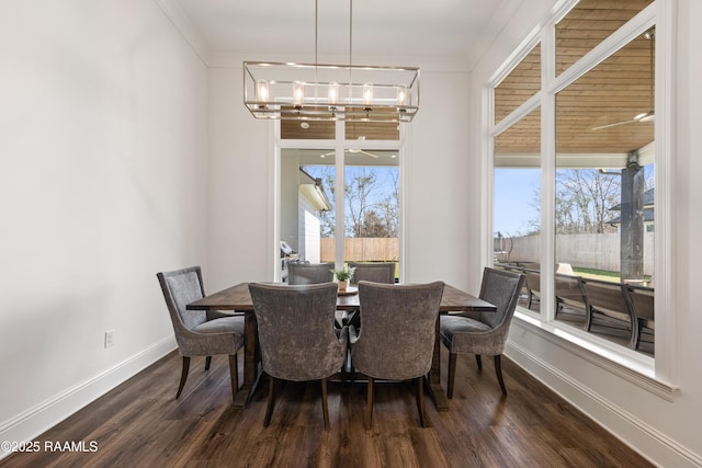 dining space with an inviting chandelier, dark wood-type flooring, plenty of natural light, and crown molding