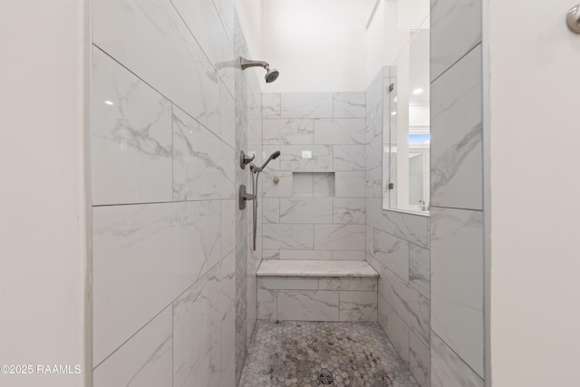 bathroom with a tile shower