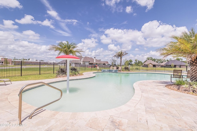 view of pool with pool water feature and a patio