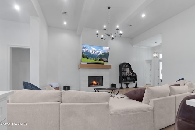 living room with visible vents, recessed lighting, a brick fireplace, and wood finished floors