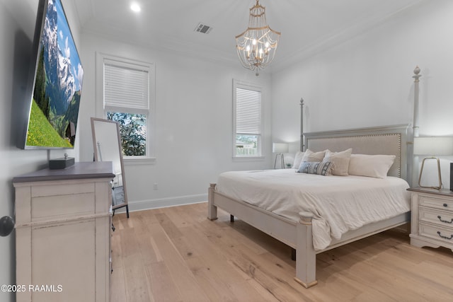 bedroom featuring visible vents, multiple windows, light wood-style floors, and ornamental molding