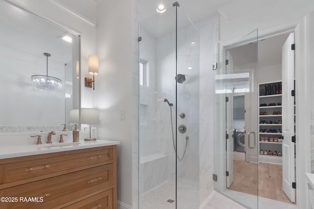 bathroom with vanity and a shower with door