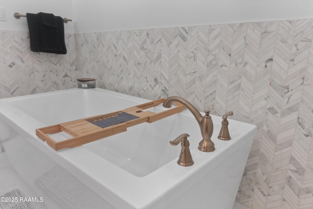 bathroom featuring tile walls and a washtub