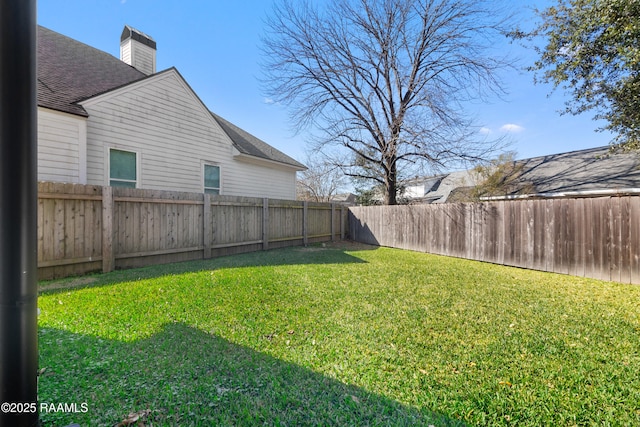 view of yard with a fenced backyard