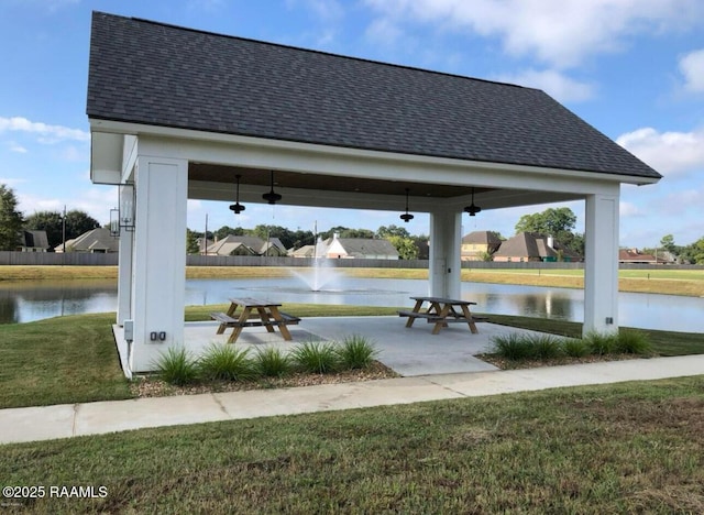 exterior space with a yard, a gazebo, and a water view