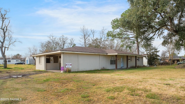 rear view of property with a lawn