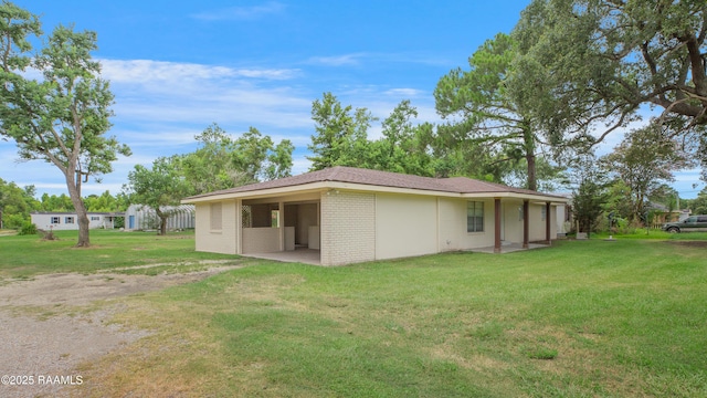 6903 W Congress, Duson, LA 70529 - back of house featuring a yard and brick siding