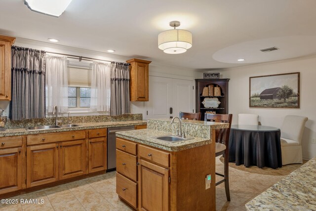 kitchen with dishwasher, visible vents, a kitchen breakfast bar, and a sink