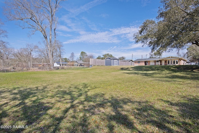 view of yard featuring a storage unit and an outdoor structure