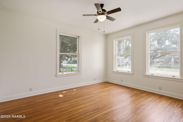 empty room with crown molding, ceiling fan, and hardwood / wood-style floors