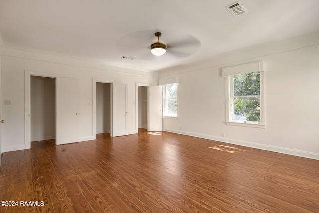 spare room with dark hardwood / wood-style floors and ceiling fan