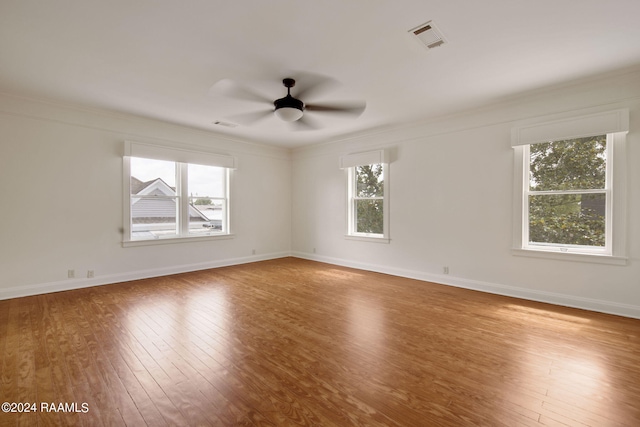 spare room with crown molding, wood-type flooring, and ceiling fan