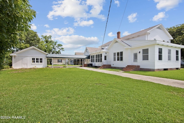 rear view of house featuring a lawn