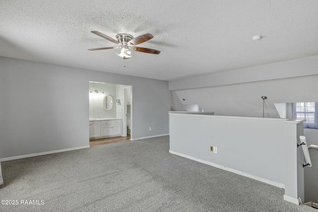 spare room with ceiling fan, carpet flooring, and a textured ceiling