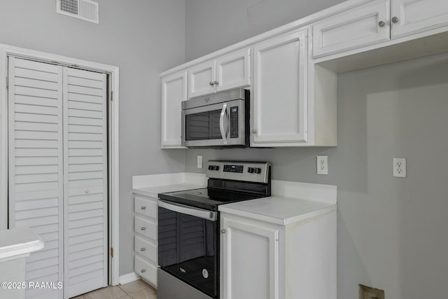 kitchen featuring stainless steel appliances and white cabinets