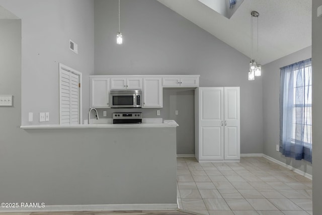 kitchen with stainless steel appliances, white cabinetry, hanging light fixtures, and kitchen peninsula