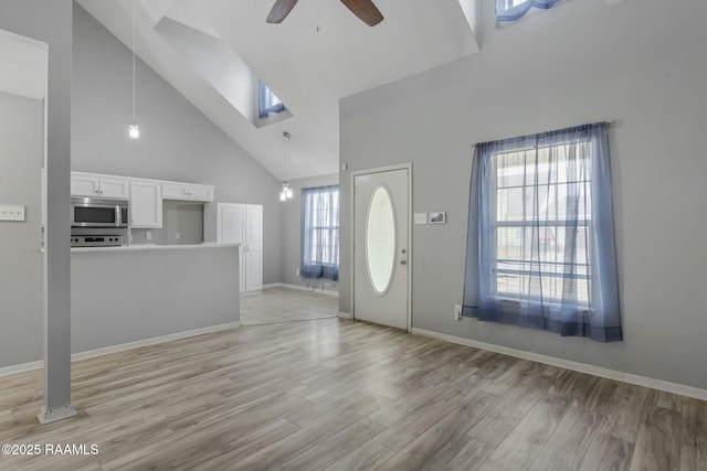 entrance foyer featuring high vaulted ceiling, light hardwood / wood-style floors, and ceiling fan