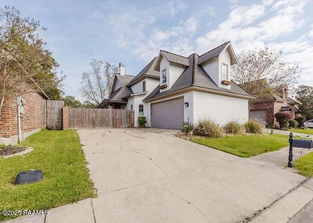 view of side of home featuring a garage and a yard