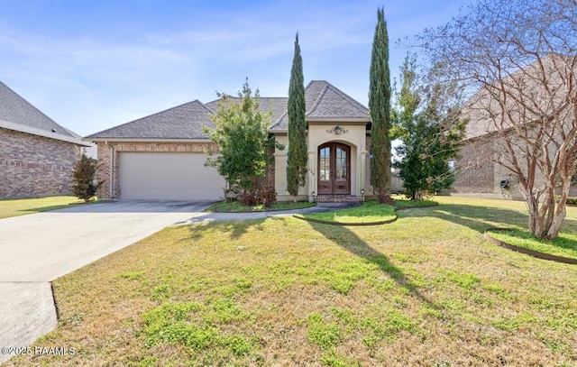 french country home with a garage, a front lawn, and french doors