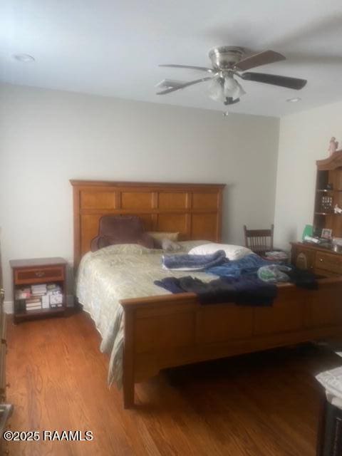 bedroom featuring ceiling fan and dark hardwood / wood-style floors