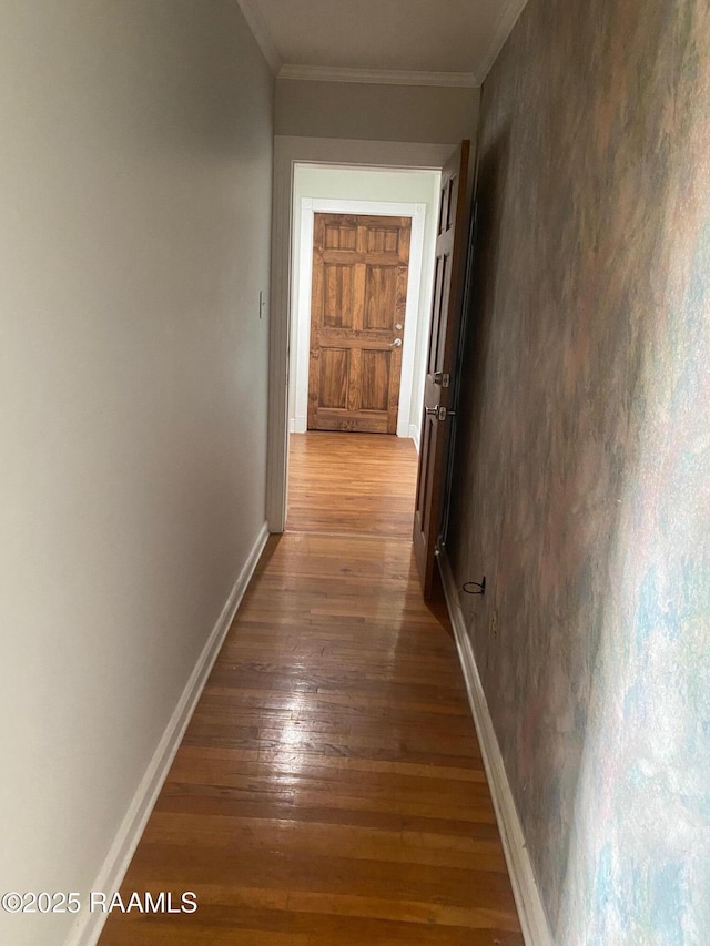 hallway featuring hardwood / wood-style flooring and crown molding