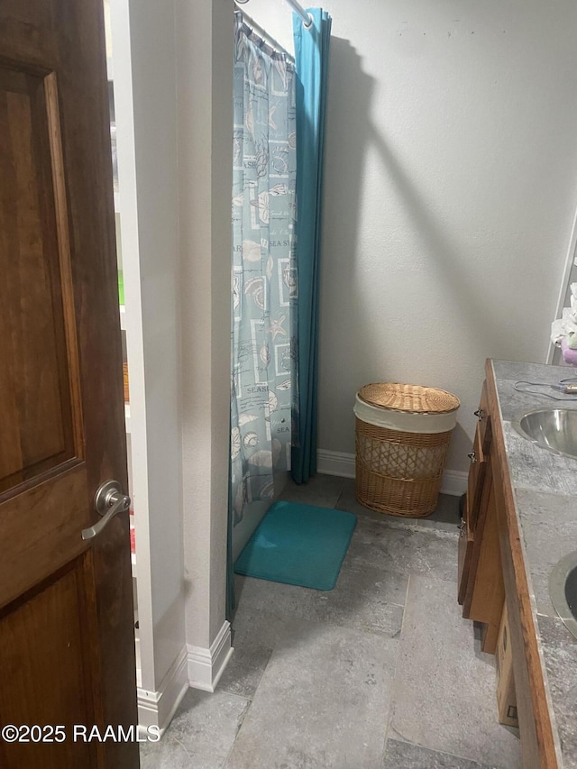 bathroom featuring vanity and a shower with shower curtain