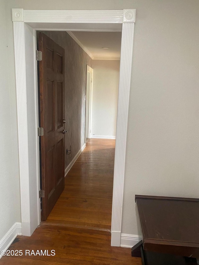 hallway with ornamental molding and dark hardwood / wood-style flooring