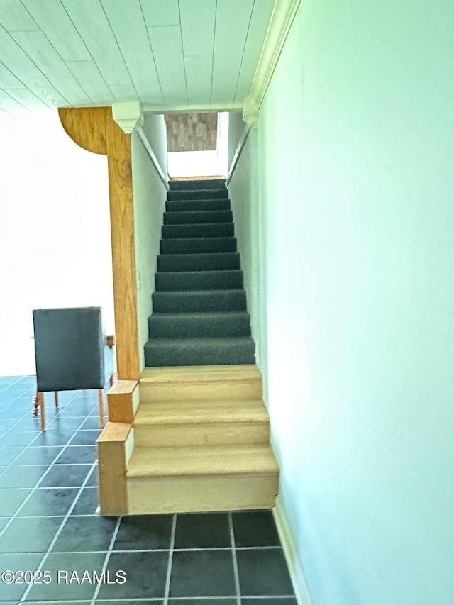 stairway featuring tile patterned floors and wood ceiling