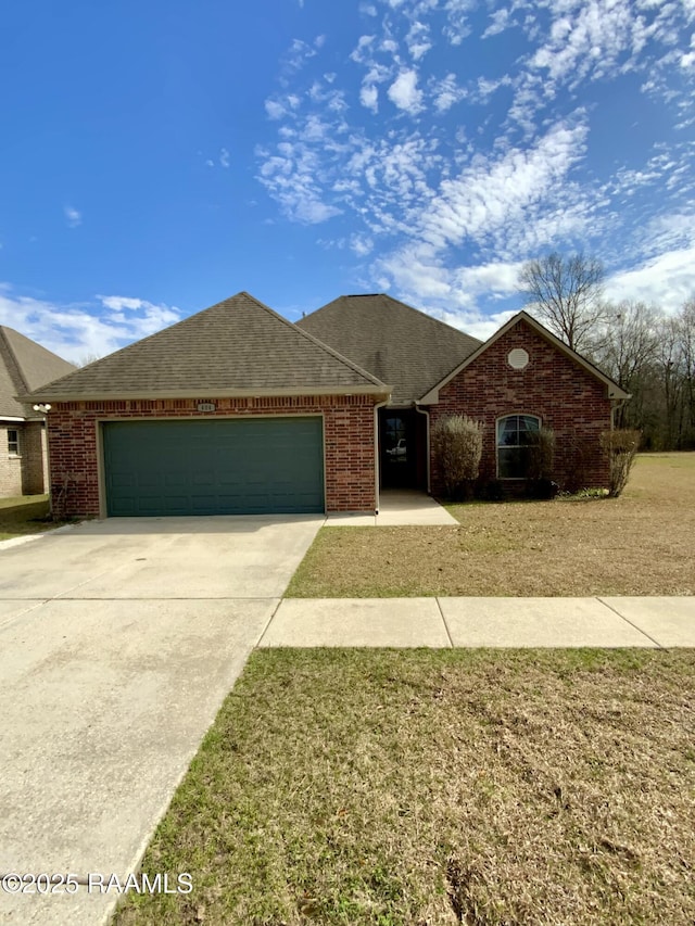 single story home with a garage and a front yard