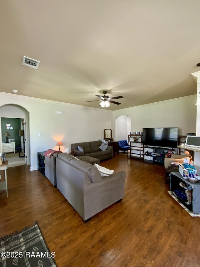 living room with ornamental molding, dark hardwood / wood-style floors, and ceiling fan