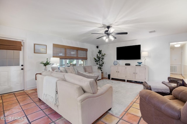 living room featuring light tile patterned flooring and ceiling fan