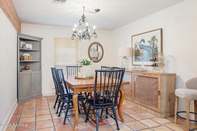 dining space with light tile patterned floors and a chandelier