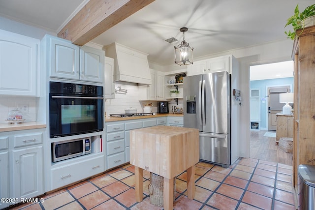 kitchen with white cabinetry, wooden counters, appliances with stainless steel finishes, pendant lighting, and decorative backsplash