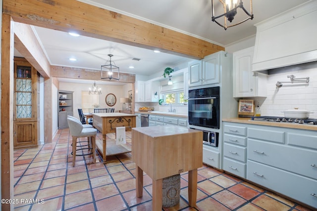 kitchen featuring pendant lighting, white cabinetry, a kitchen breakfast bar, a center island, and stainless steel appliances