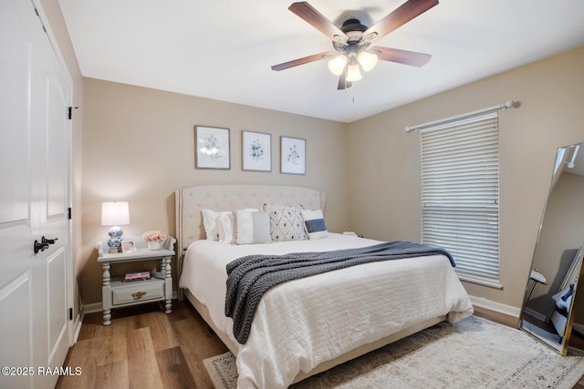 bedroom with hardwood / wood-style flooring and ceiling fan