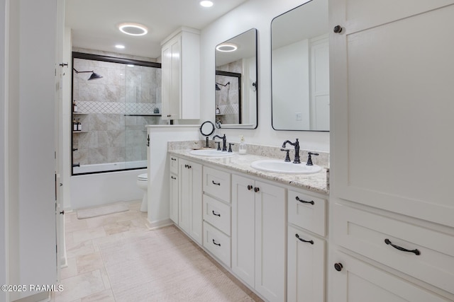 full bathroom featuring enclosed tub / shower combo, vanity, and toilet