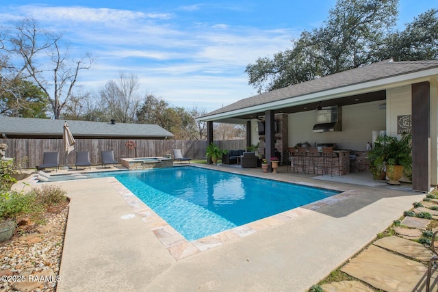 view of swimming pool with an in ground hot tub, an outdoor bar, and a patio area