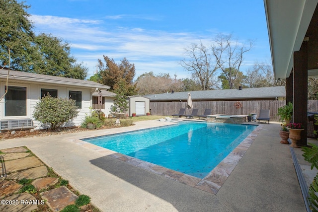 view of pool featuring a shed, a patio, and an in ground hot tub