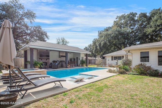 view of swimming pool with a hot tub, a lawn, and a patio area