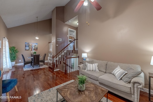 living room featuring hardwood / wood-style floors, high vaulted ceiling, and ceiling fan